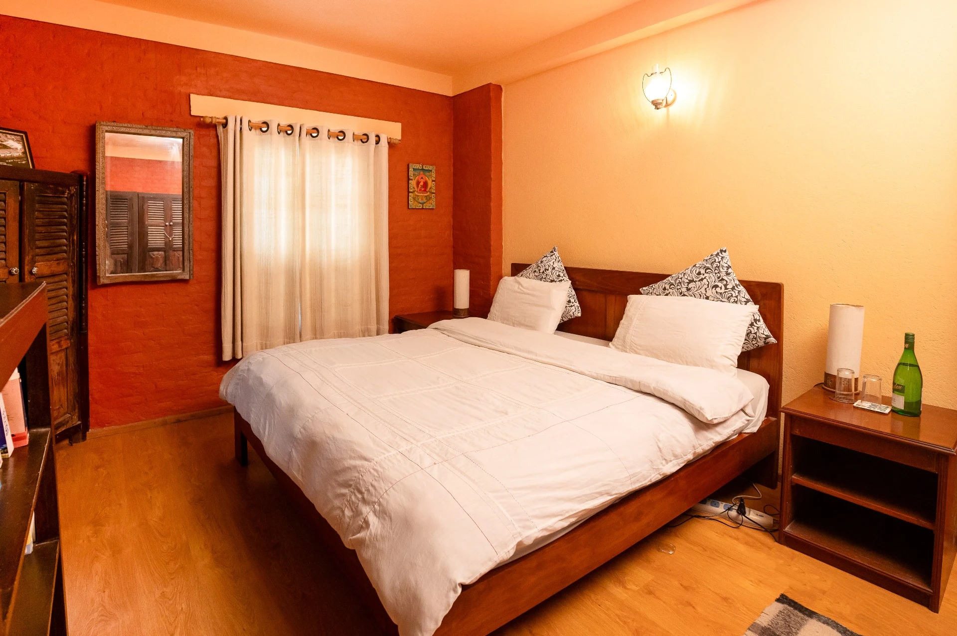 Double bedroom with white bedding and warm brick walls
